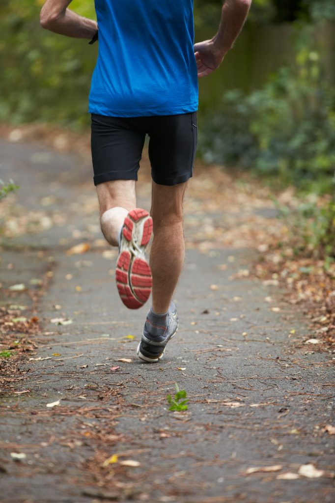 Close Up Of Jogger's Feet Running On Path