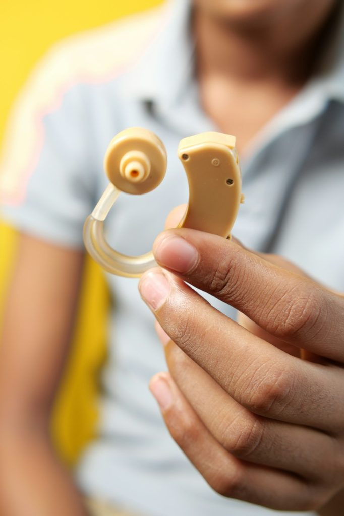 Hearing aid concept, teenage boy with hearing problems.