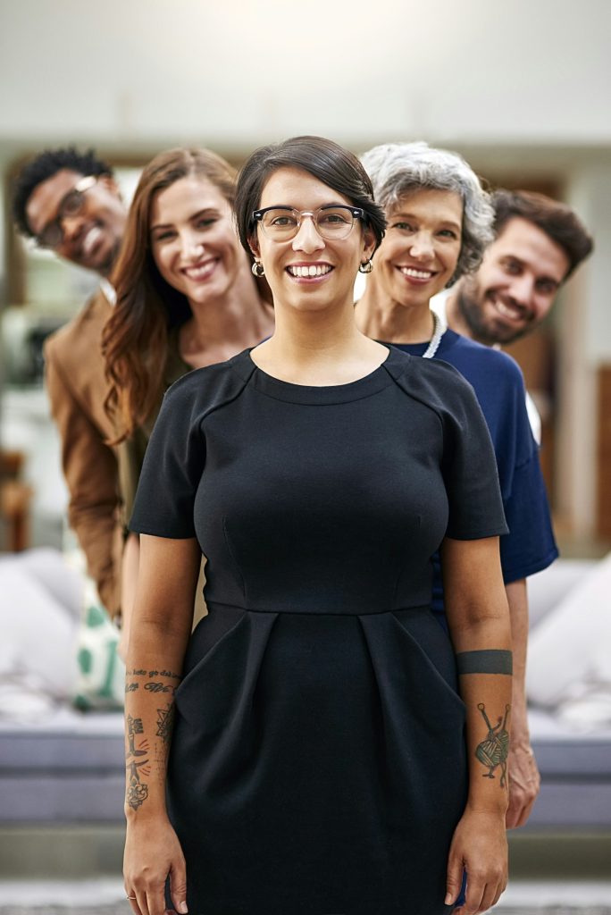 Portrait of a group of businesspeople standing in a line in an office