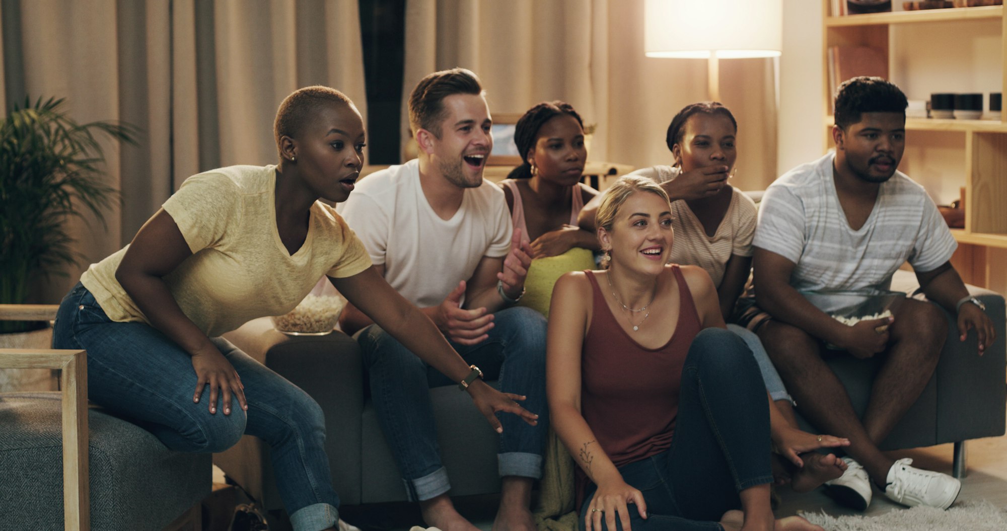 Shot of a group of a diverse group of friends relaxing in the lounge at home