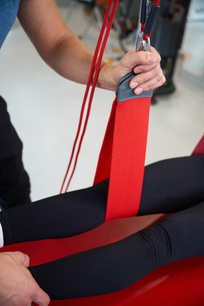 Specialist uses a redcord in a rehabilitation program for client